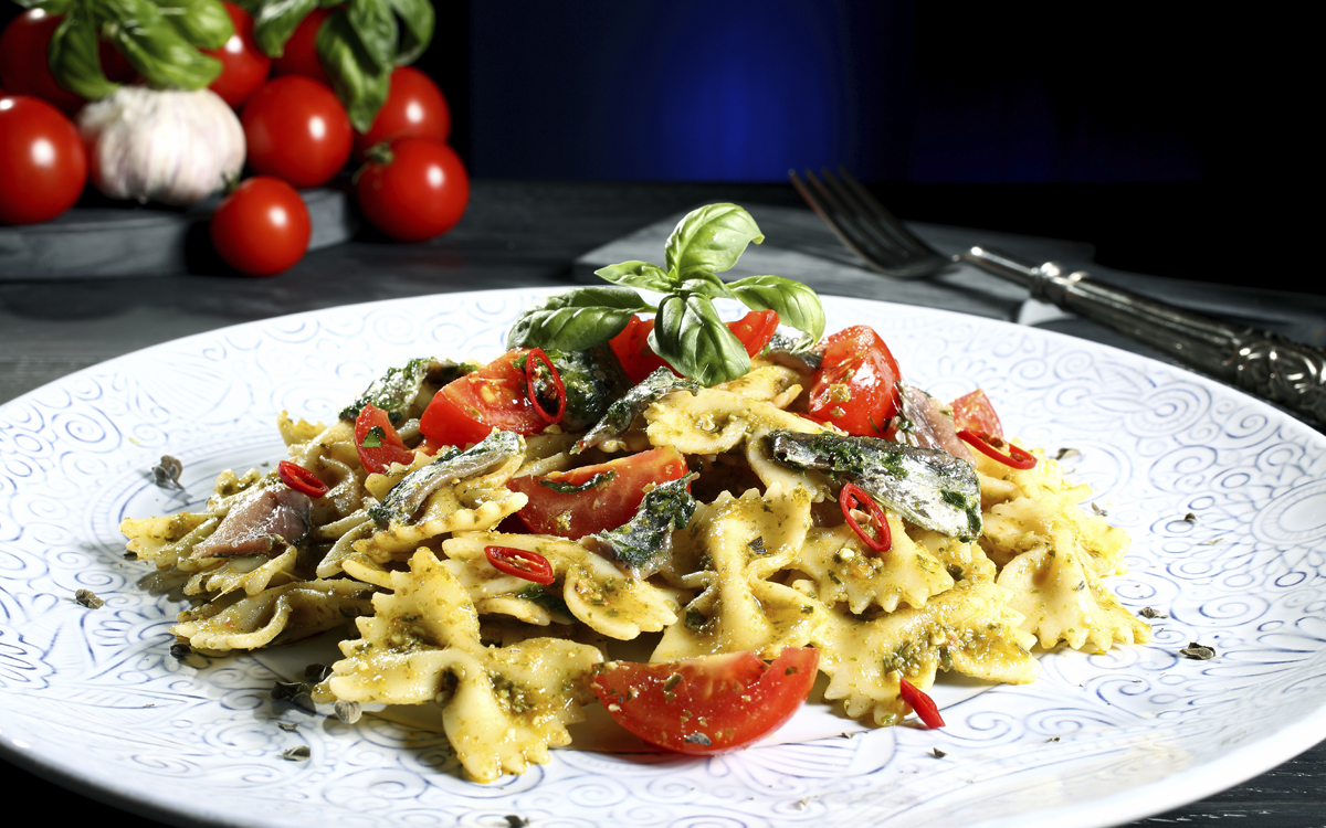 Pasta al pesto con anchoas y tomates